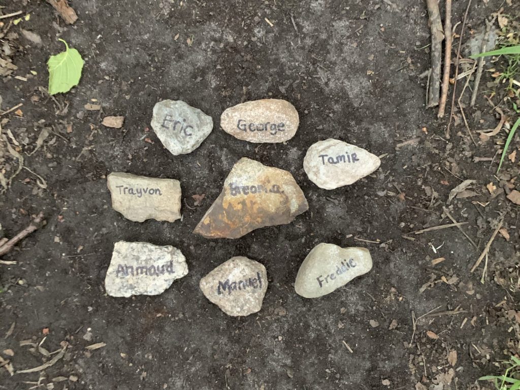 A photo of 8 rocks of black individuals who were murdered by police/civilian brutality. I carried the rocks for my entire journey.